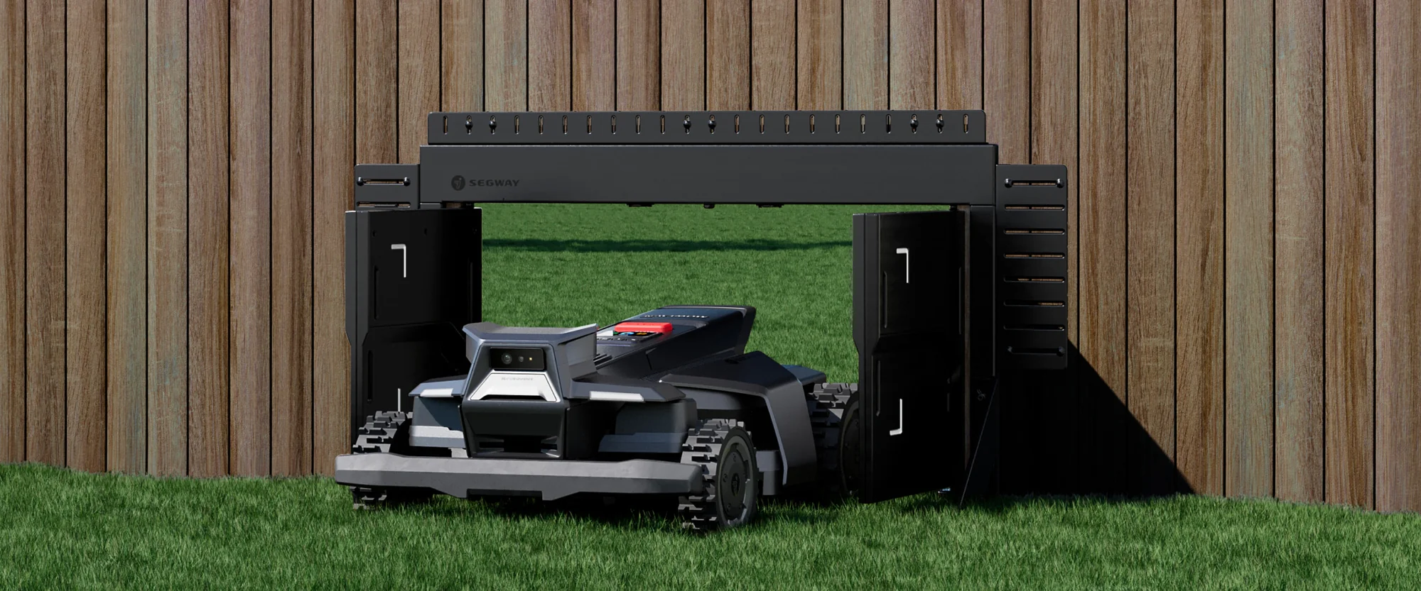 Segway robotic mower passing through a purpose-built gate in a wooden fence
